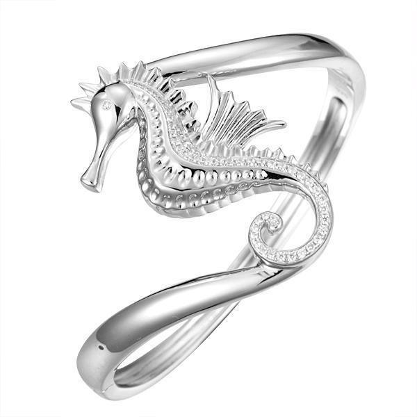 The picture shows a 925 sterling silver seahorse bangle with topaz.