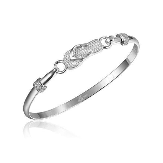 In this photo there is a sterling silver beach slipper bangle with topaz gemstones.