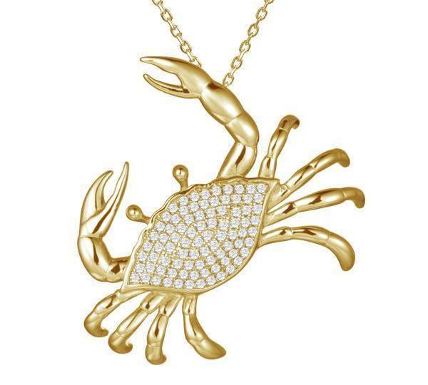 The picture shows a 925 sterling silver, yellow gold plated, pavé blue crab pendant with cubic zirconia.