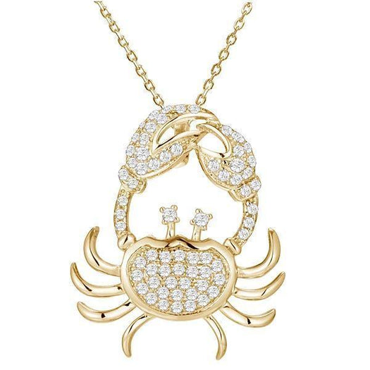 The picture shows a 925 sterling silver, yellow gold plated, pavé crab pendant with topaz.