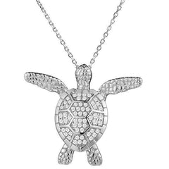 In this photo there is a white gold sea turtle pendant with cubic zirconia.