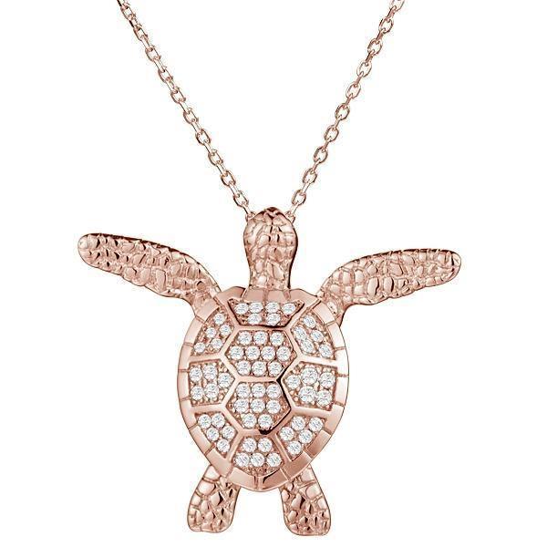 The picture shows a 14K rose gold sea turtle pendant with pavé diamonds.