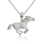 In this photo there is a sterling silver galloping horse pendant with sapphire and topaz gemstones.