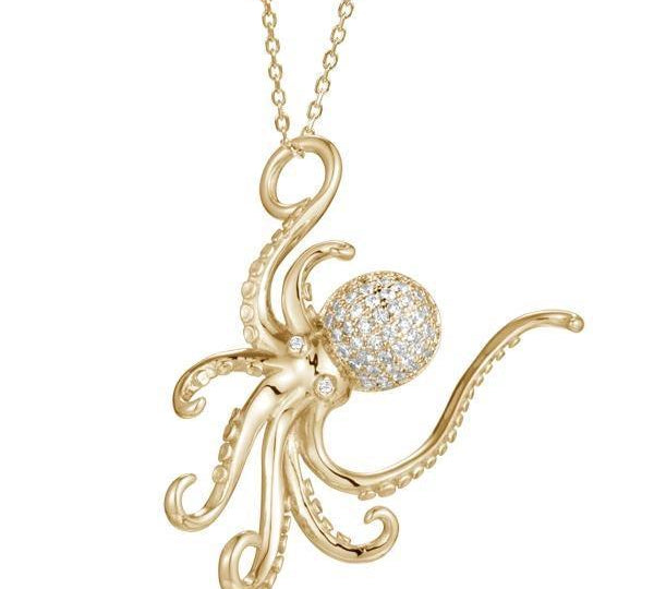 The picture shows a 925 sterling silver, yellow gold vermeil, pavé octopus pendant with topaz.