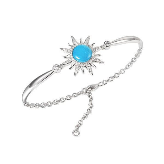 In this photo there is a 925 sterling silver sun bracelet with blue larimar, topaz, and aquamarine gemstones.