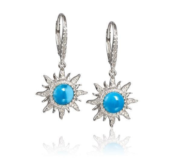 In this photo there is a pair of sterling silver sun earrings with blue larimar and topaz gemstones.