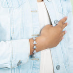 The picture shows a model wearing a 925 sterling silver white gold-plated sea turtle bracelet with cubic zirconia.