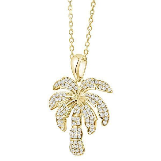 In this photo there is a yellow gold palm tree pendant with topaz gemstones.