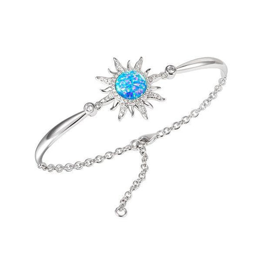 In this photo there is a sterling silver sun bracelet with aquamarine, topaz, and one blue opalite gemstone.
