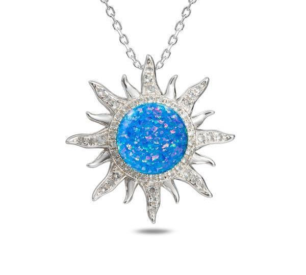 In this photo there is a sterling silver sun pendant with topaz and blue opalite gemstones.