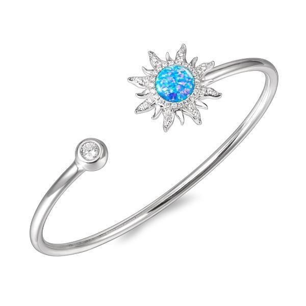 In this photo there is a 925 sterling silver sun bangle with topaz, aquamarine, and blue opalite gemstones