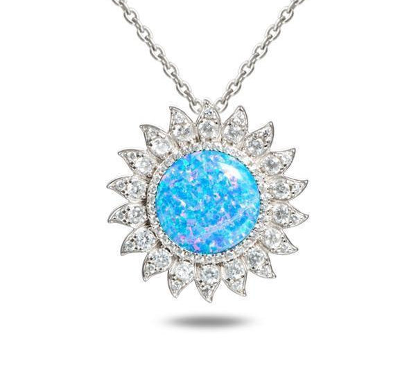 In this photo there is a sterling silver sunflower pendant with topaz and one blue opalite gemstone.