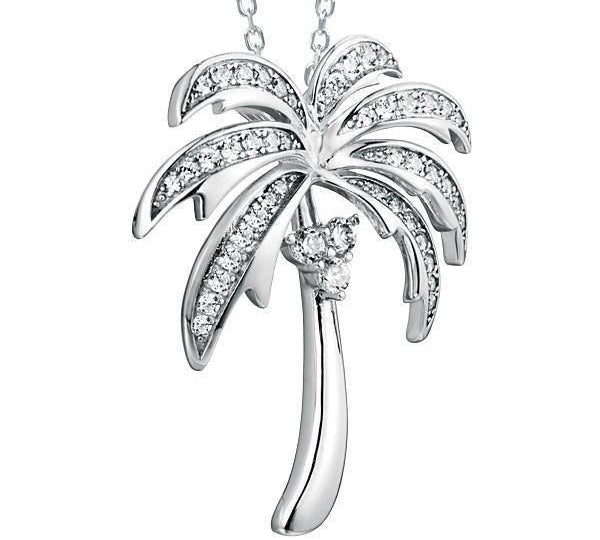 In this photo there is a white gold palm tree pendant with topaz gemstones.