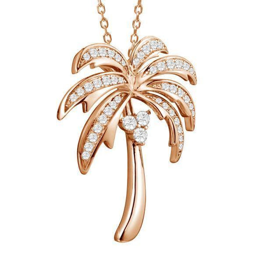 In this photo there is a rose gold palm tree pendant with topaz gemstones.