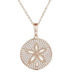 The picture shows a large 14K rose gold pavé sand dollar pendant with diamonds.