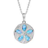 The picture shows a 925 sterling silver pavé sand dollar pendant with opalite and topaz.