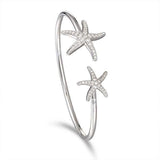 The picture shows a 925 sterling silver two starfish bangle with topaz.