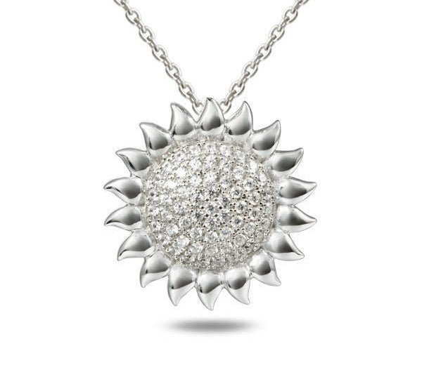 In this photo there is a white gold sunflower pendant with topaz gemstones.