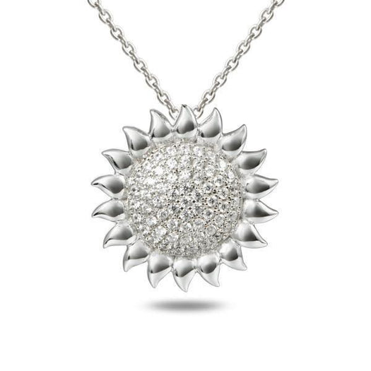 In this photo there is a white gold sunflower pendant with topaz gemstones.