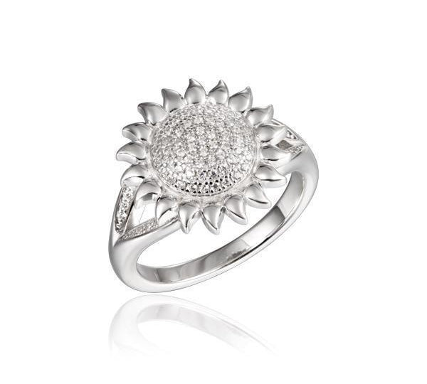 In this photo there is a 925 sterling silver sunflower ring with a split band and topaz gemstones.