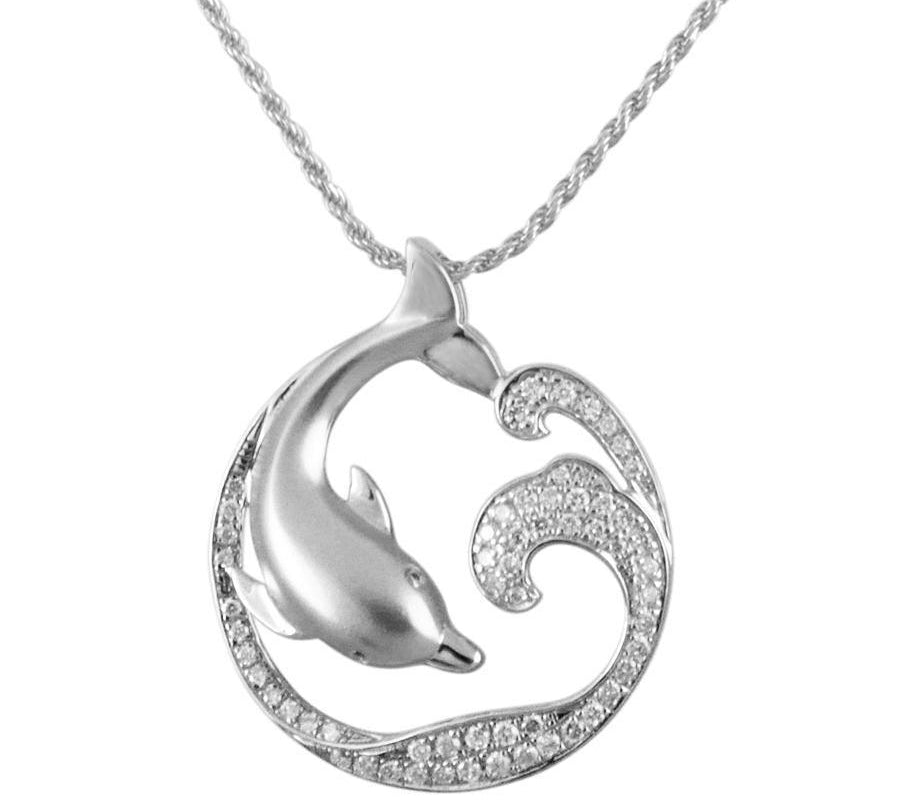 The picture shows a 925 sterling silver, white gold vermeil, dolphin and wave pendant with topaz.