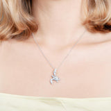 The picture shows a model wearing a 925 sterling silver, white gold vermeil, sea turtle pendant with topaz.