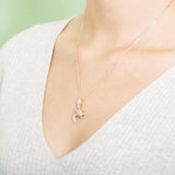 The picture shows a model wearing a 925 sterling silver, yellow gold vermeil, sea turtle pendant with topaz.