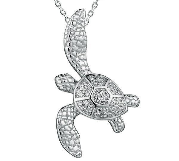 The picture shows a 925 sterling silver, white gold vermeil, sea turtle pendant with topaz.