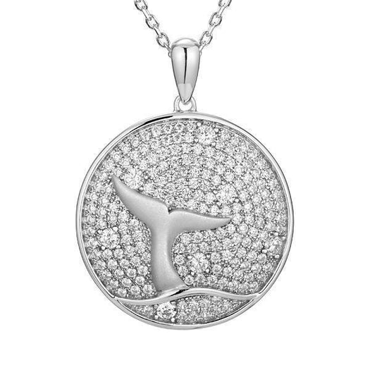 The picture shows a 925 sterling silver, white gold vermeil, pavé whale tail medallion pendant with topaz.