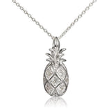 In this photo there is a sterling silver pineapple pendant with topaz gemstones.