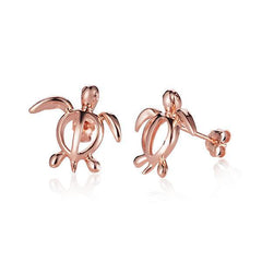 In this picture there is a pair of 14k rose gold sea turtle stud earrings.