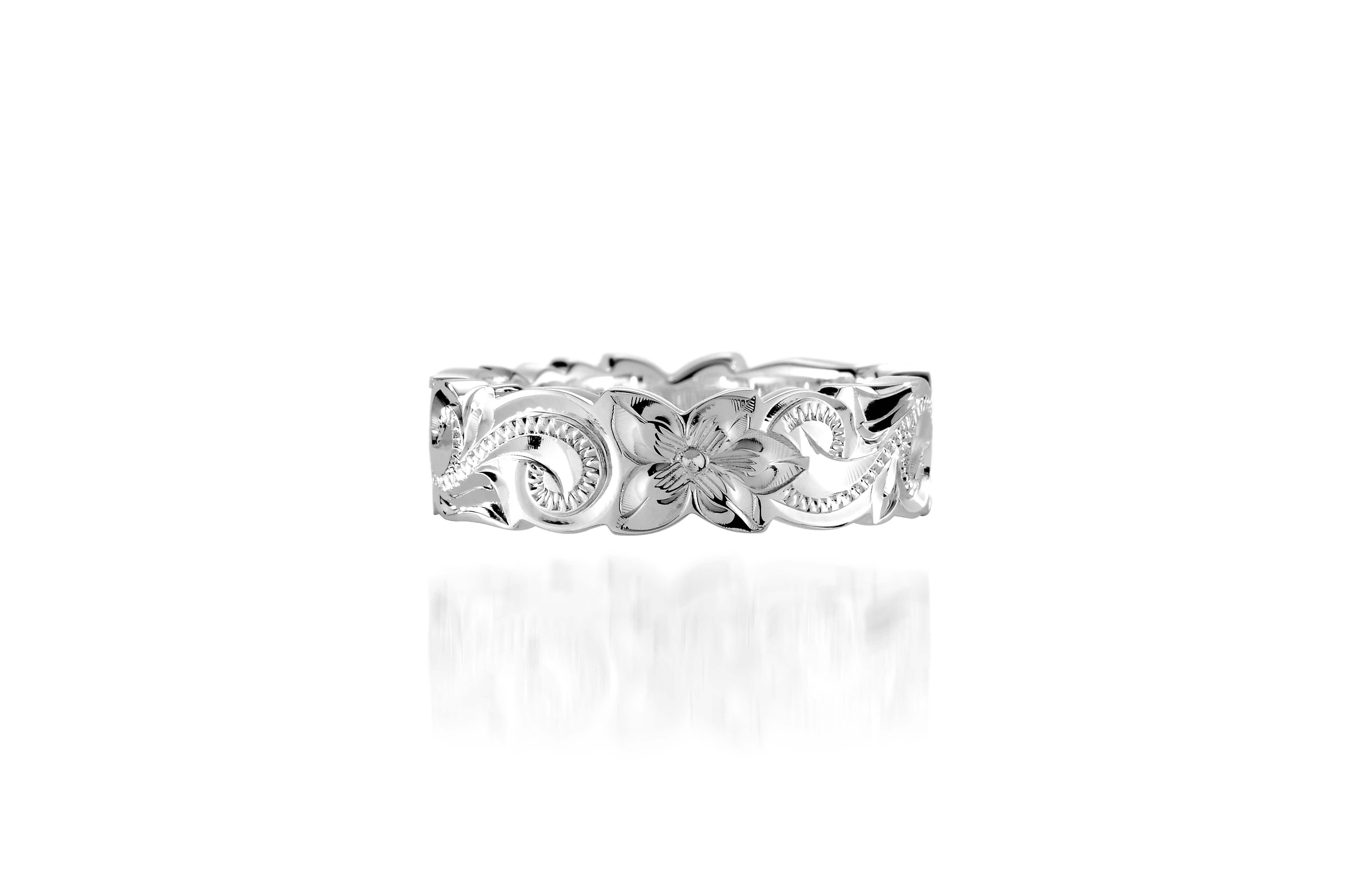 In this photo there is a sterling silver cut out ring with flower and scroll hand engravings.