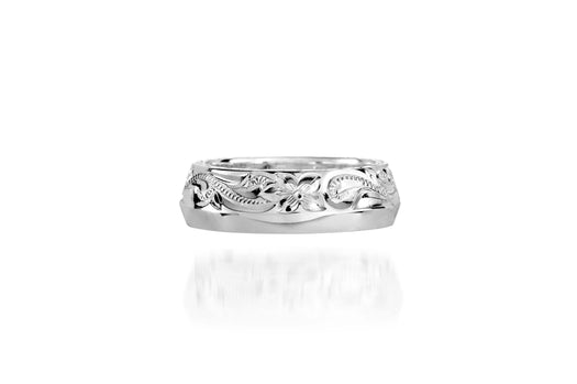 In this photo there is a sterling silver ring with flower and scroll hand engravings.