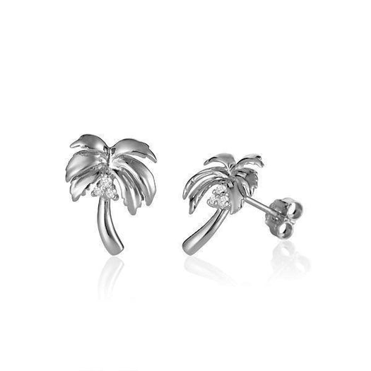 In this photo there is a pair of large 14k white gold queen palm tree stud earrings with diamond coconuts.