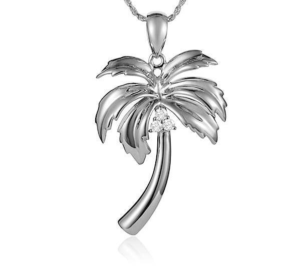 In this photo there is a sterling silver palm tree pendant with topaz gemstones.