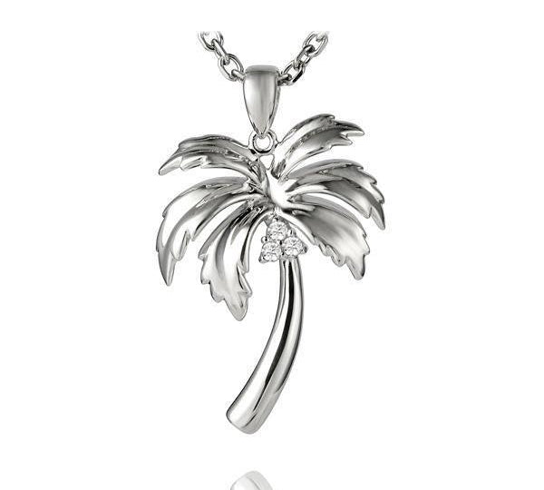 In this photo there is a sterling silver palm tree pendant with topaz gemstones.