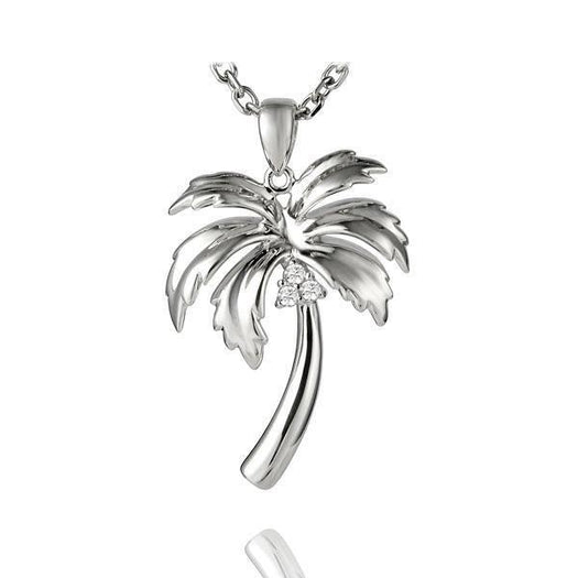 In this photo there is a sterling silver palm tree pendant with topaz gemstones.