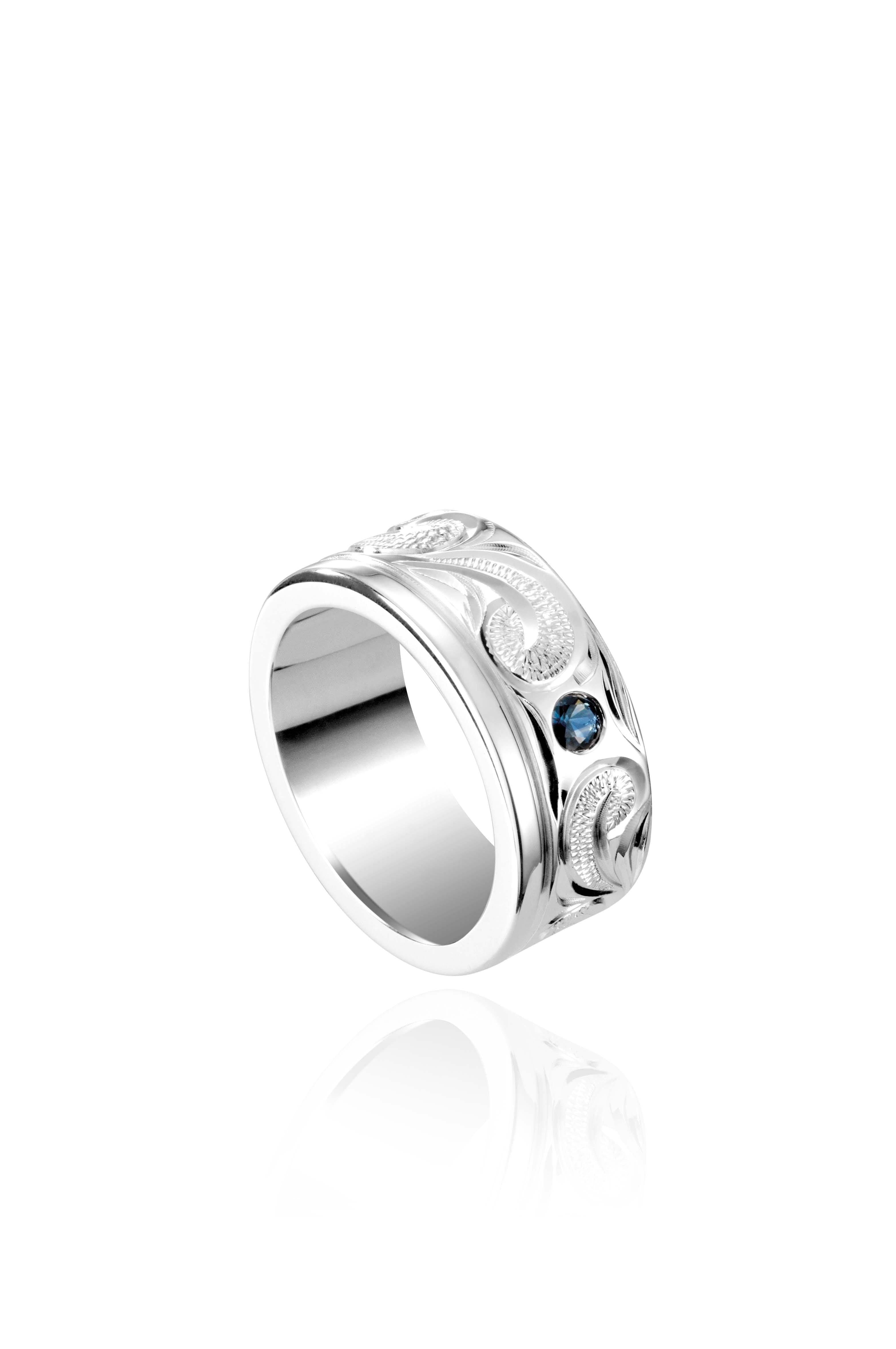 The picture shows a 925 sterling silver ring with scroll hand-engravings and sapphire.