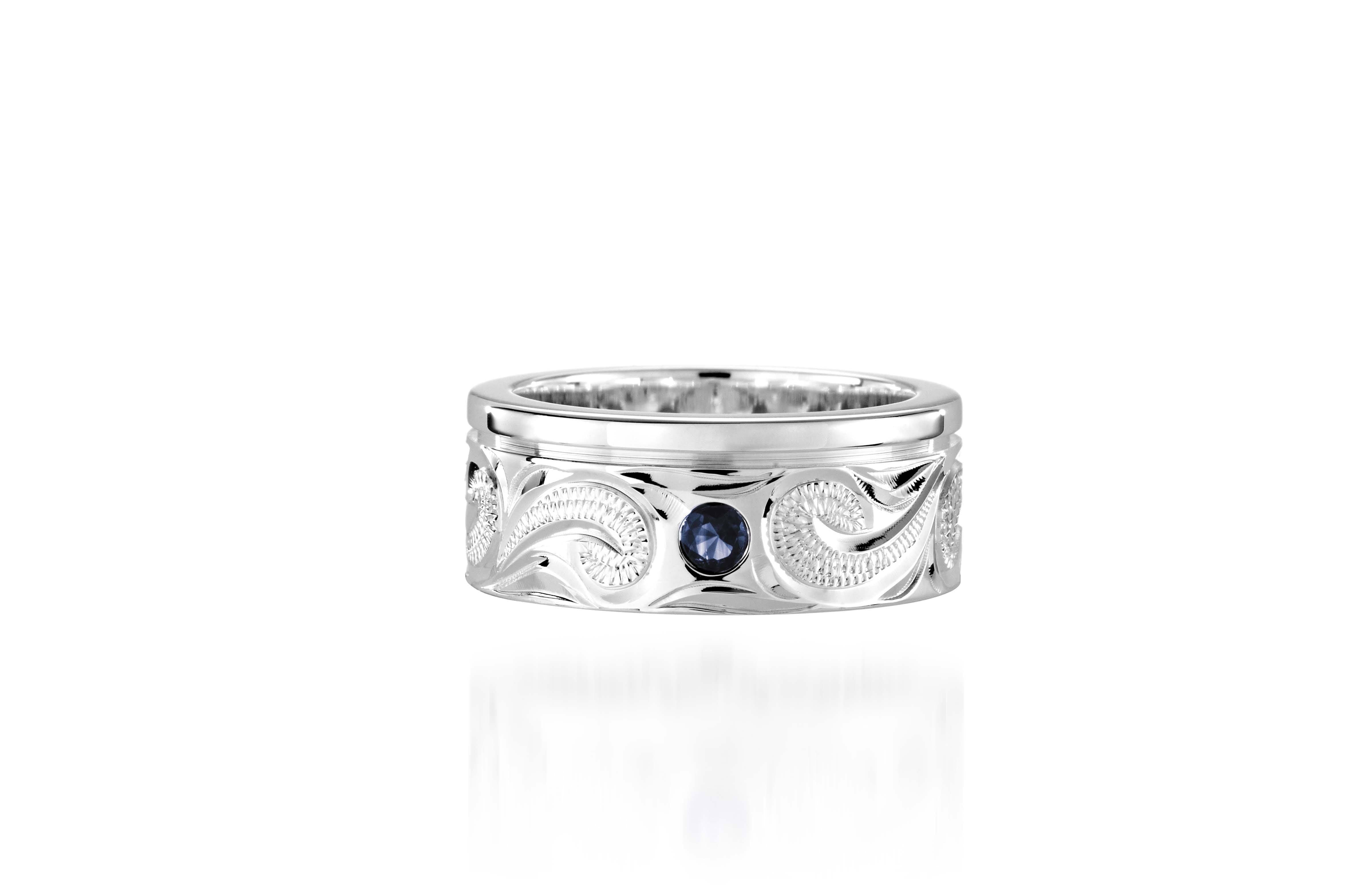 The picture shows a 925 sterling silver ring with scroll hand-engravings and sapphire.