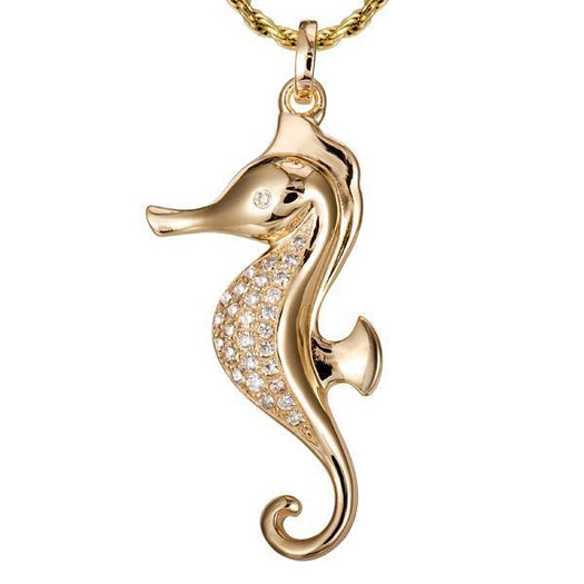 In this photo there is a yellow gold seahorse pendant with topaz gemstones.