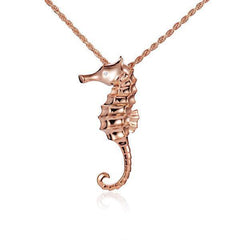 The picture shows a 14K rose gold seahorse pendant with a diamond.