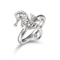 In this photo there is a 925 sterling silver seahorse ring with topaz eyes.