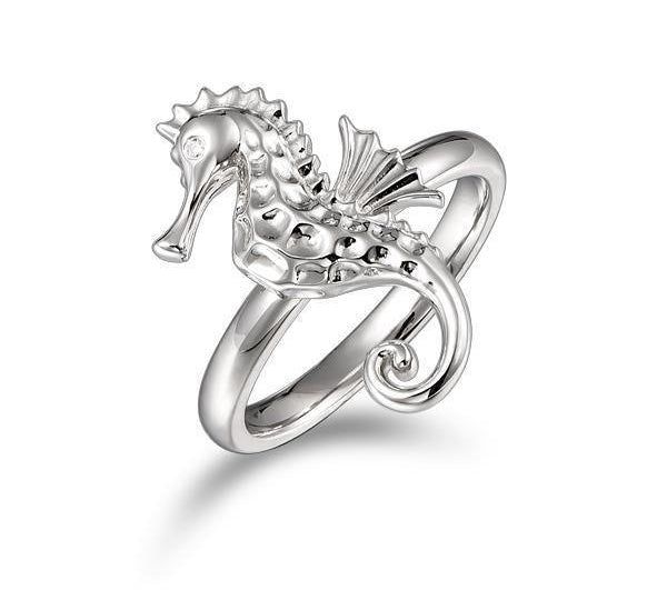 In this photo there is a 925 sterling silver seahorse ring with topaz eyes.