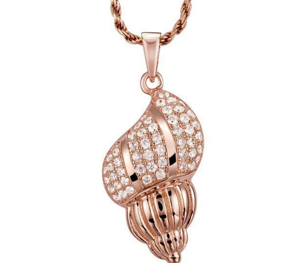 The picture shows a 14K rose gold seashell pendant with diamonds.