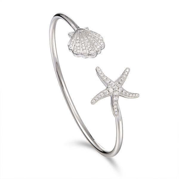 The picture shows a 925 sterling silver starfish and oyster bangle with topaz.