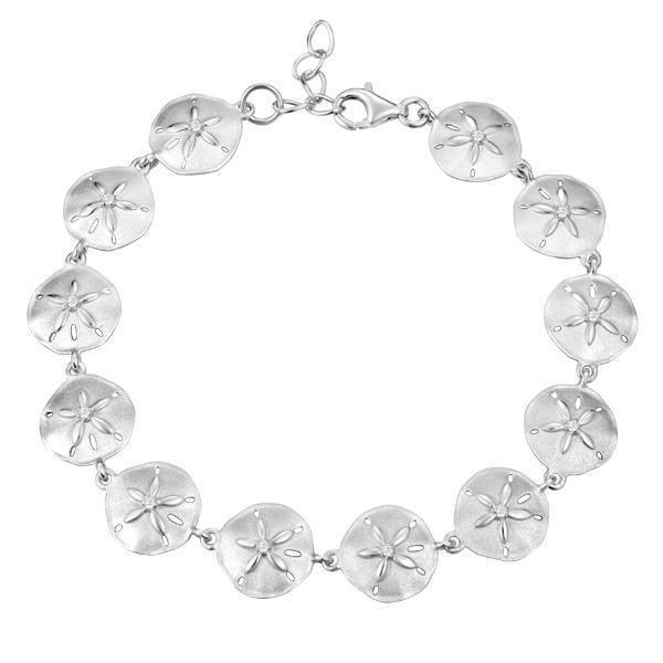 The picture shows a white gold sand dollar bracelet with topaz