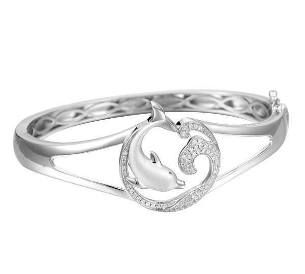 The picture shows a 925 sterling silver dolphin and wave bangle with topaz.