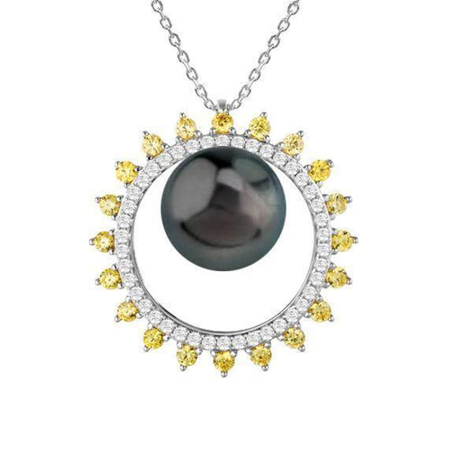 In this photo there is a white gold sun pendant with yellow and white diamonds and one dark pearl.