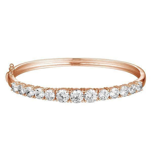 The photo shows a rose gold tennis bracelet bangle with topaz.