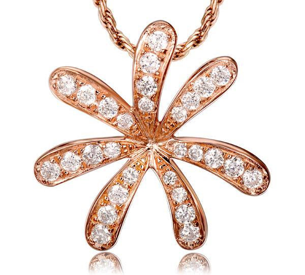 In this photo there is a rose gold tiare gardenia pendant with topaz gemstones.